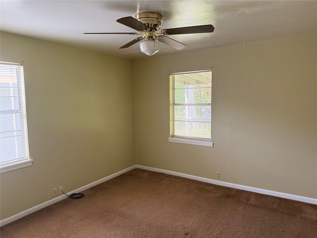 Carpeted empty room featuring baseboards and a ceiling fan | Image 16