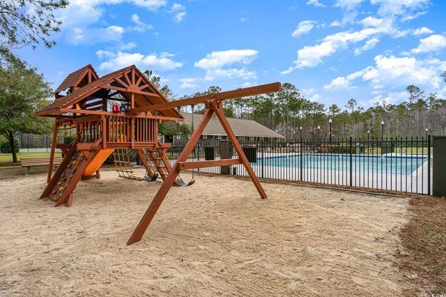 View of jungle gym featuring a community pool | Image 36