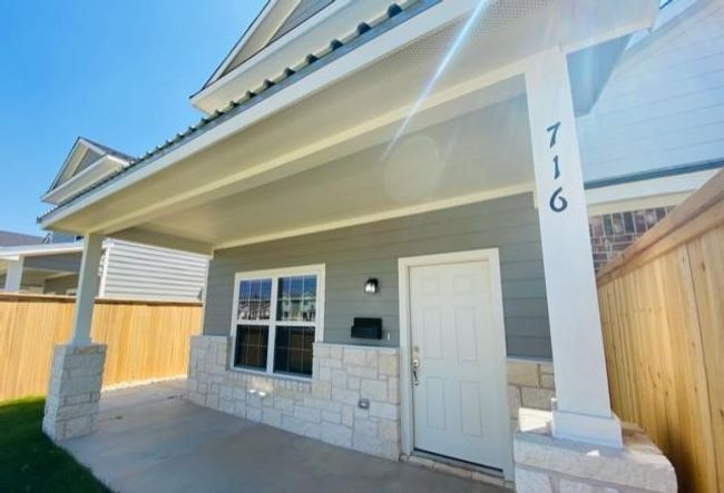 Property entrance featuring a patio and stone siding | Image 12