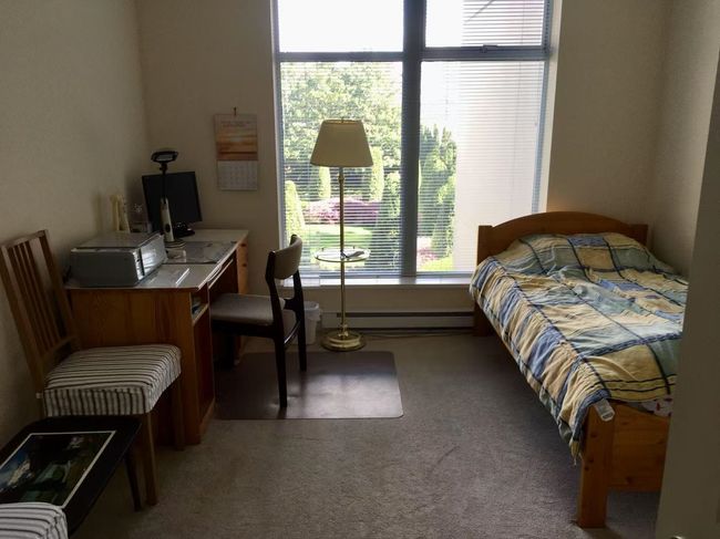 Carpeted bedroom featuring a baseboard radiator | Image 7