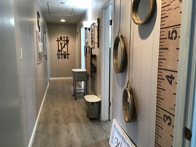 Hallway goes to laundry and bath for secondary bedrooms. | Image 29