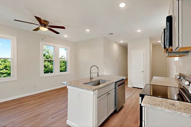 Kitchen with a sink, stainless steel appliances, healthy amount of natural light, light wood-style flooring, and recessed lighting | Image 4