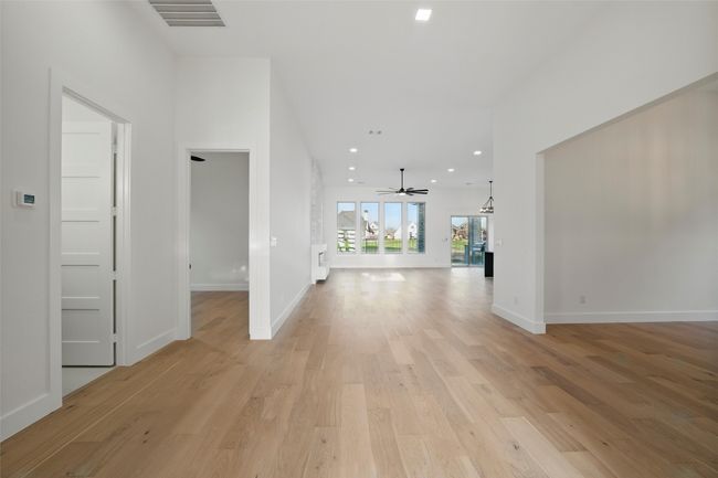 Hall with recessed lighting, baseboards, light wood finished floors, and visible vents | Image 24