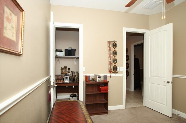 Bedroom with light carpet and baseboards | Image 23