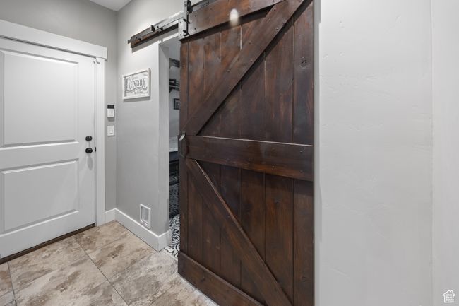 Foyer featuring a barn door and baseboards | Image 47