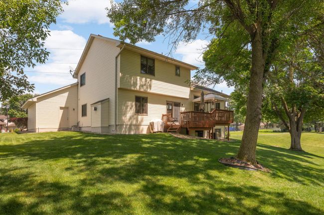 Back of home with a couple mature trees to provide shade and privacy. | Image 32