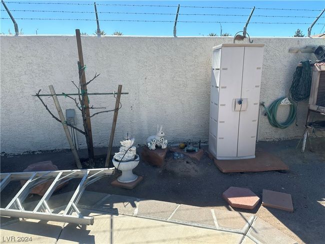 Rear stucco wall with barb wire | Image 26