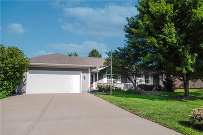 Ranch-style home with a garage and a front yard | Image 2