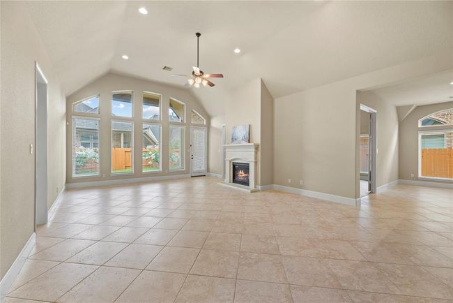 The family room is massive with a wall of windows to flood the room with natural light. | Image 12