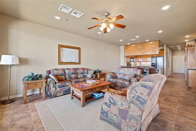 Living area with ceiling fan, tile patterned floors, visible vents, and recessed lighting | Image 6