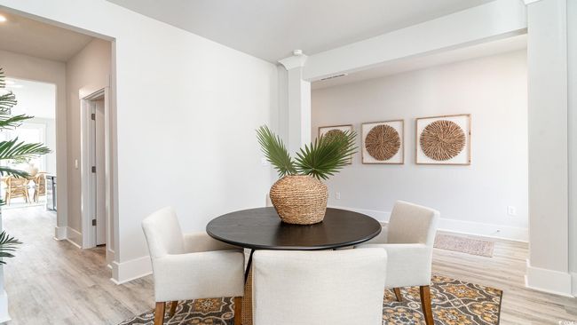 Dining room featuring light wood-style flooring and baseboards | Image 4