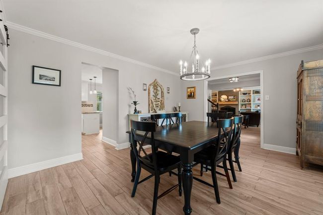 The dining room opens to the kitchen and the living area, offering a spacious and inviting atmosphere. | Image 13