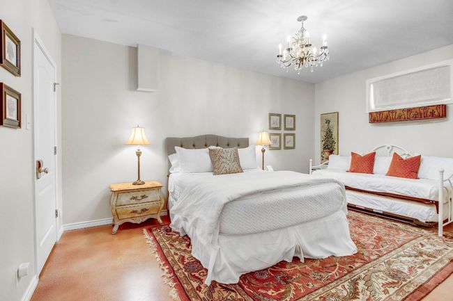 Bedroom featuring a chandelier and baseboards | Image 28