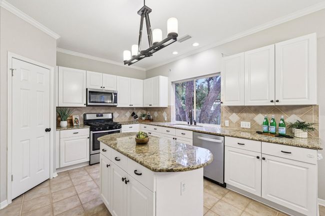 The heart of the home: an open-concept kitchen with ample cabinetry and prep space. | Image 6