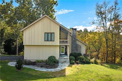 View of front of property featuring a balcony and a front yard | Image 2