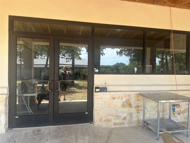 Entrance to property featuring french doors and stone siding | Image 8