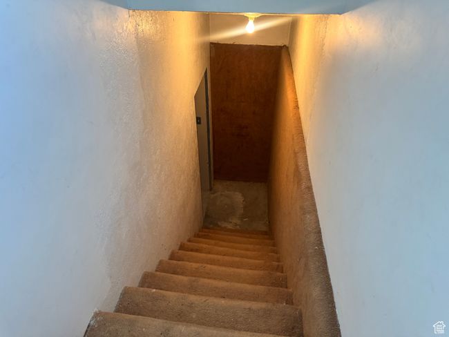 Stairs featuring a textured wall | Image 22