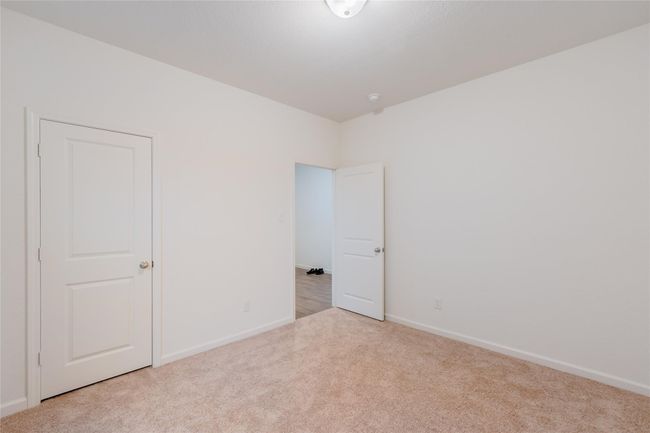 Carpeted empty room featuring baseboards | Image 5