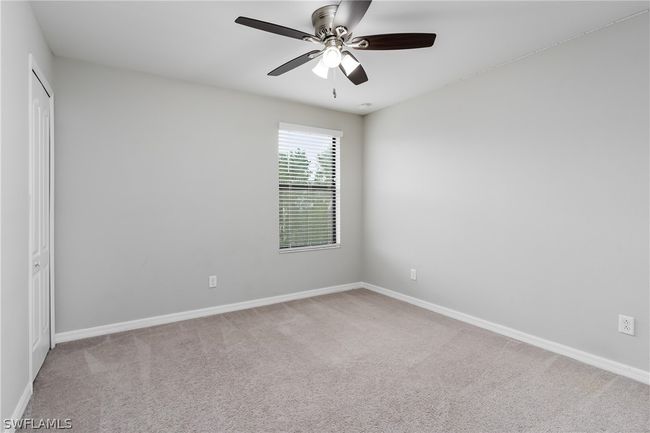 Carpeted spare room featuring ceiling fan | Image 19