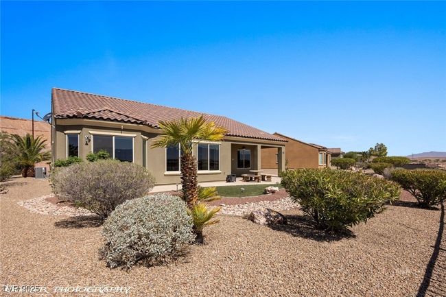 Back of property featuring a patio area, stucco siding, and a tile roof | Image 59