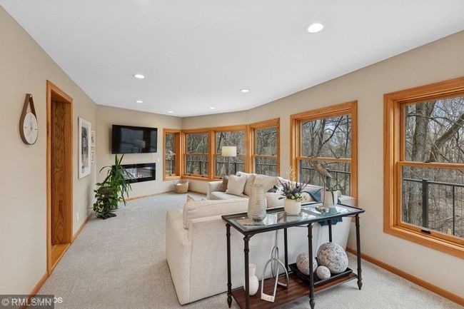 Beautiful sun room with an abundance of windows overlooking the backyard. | Image 24