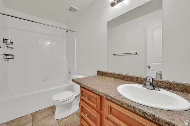 Full bath with vanity, bathtub / shower combination, and tile patterned flooring | Image 26