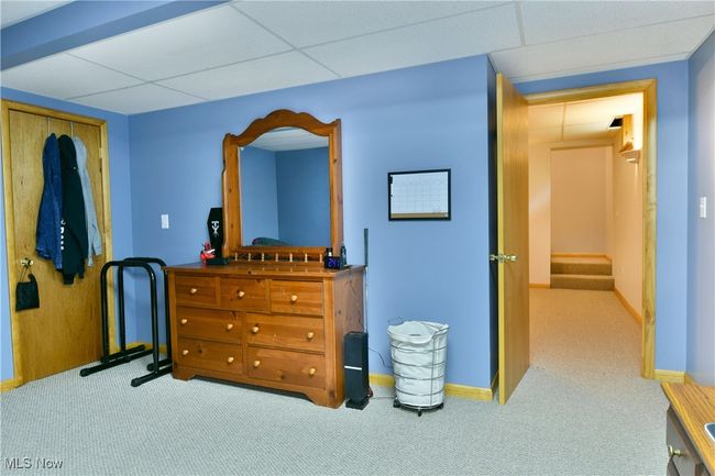 Carpeted bedroom featuring a drop ceiling and baseboards | Image 46