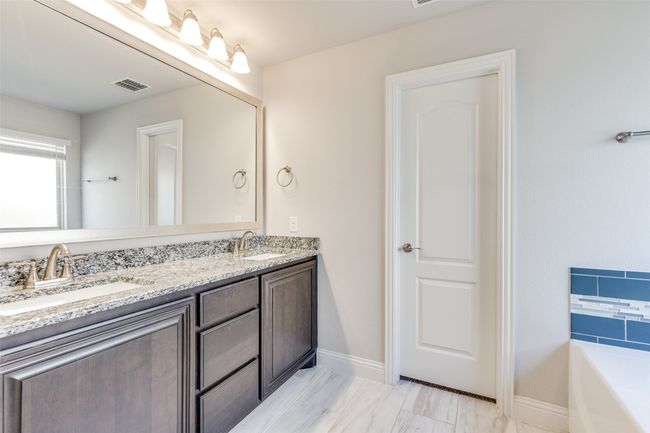 Bathroom with a bathtub, separate shower and granite countertops. | Image 15
