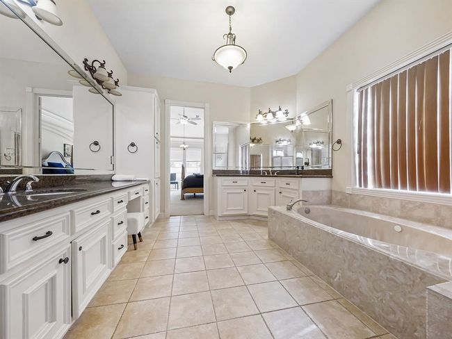 Luxurious master bathroom featuring a spacious brand new walk in shower, separate soaking tub, and elegant double sinks. | Image 27