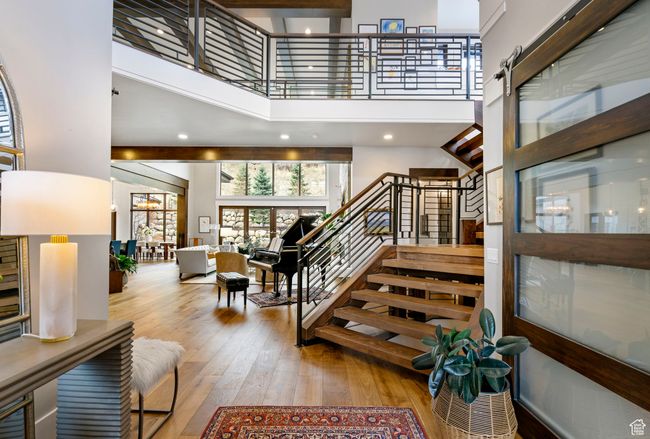 Stairway with a high ceiling and hardwood / wood-style flooring | Image 10