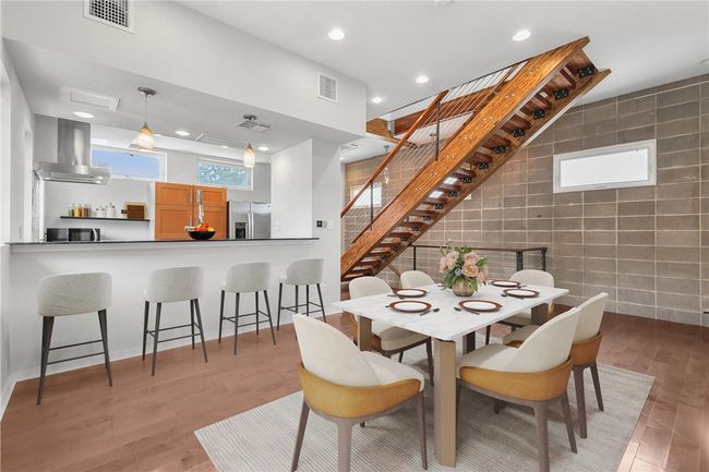 Dining area with tile walls, recessed lighting, stairway, and light wood-style floors | Image 9