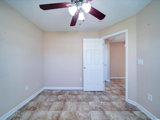 Empty room with ceiling fan and baseboards | Image 8