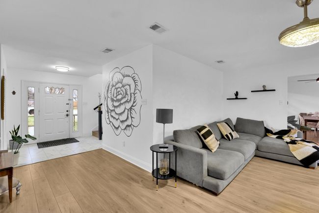 Living room with wood finished floors and a ceiling fan | Image 5
