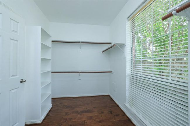 This front primary closet has a large winodw facing the front of the home and natural light. Shoe rack for storage | Image 22