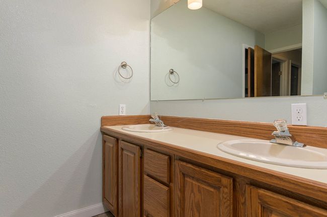 Bathroom featuring double vanity and baseboards | Image 11