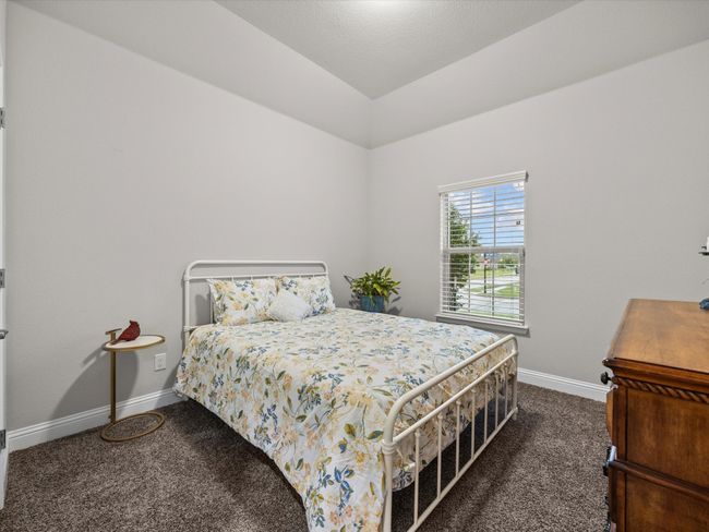 Bedroom with carpet flooring and lofted ceiling | Image 23