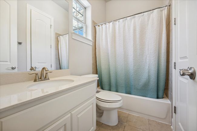 Full bathroom with shower / tub combo with curtain, toilet, tile patterned floors, and vanity | Image 31