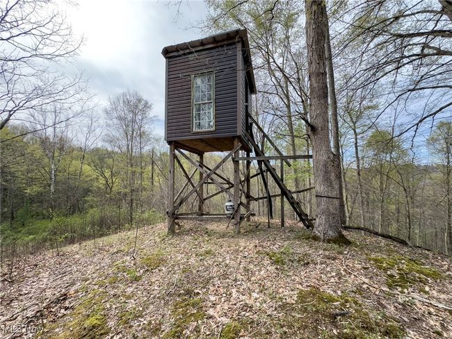 View of outdoor structure featuring a wooded view | Image 38