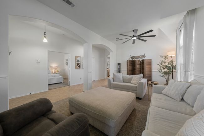 Living area with arched walkways and ceiling fan | Image 6
