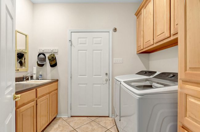 Large utility room with sink and abundant storage space | Image 12