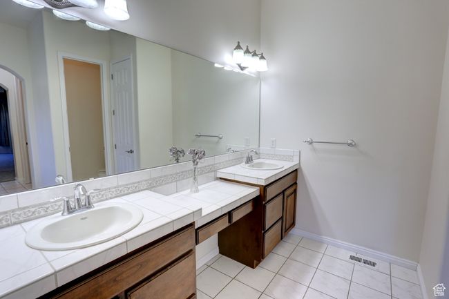 Full bath with a sink, visible vents, double vanity, and tile patterned flooring | Image 14