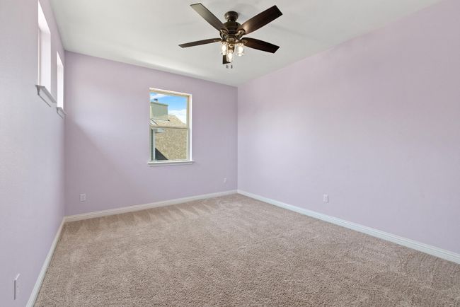 Carpeted empty room with baseboards and a ceiling fan | Image 29