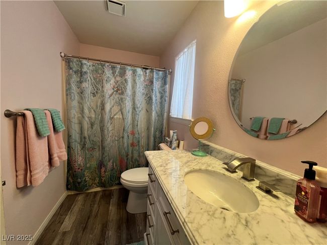 Bathroom featuring vanity, wood finished floors, and a shower with shower curtain | Image 51