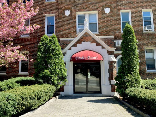View of exterior entry with brick siding and cooling unit | Image 24