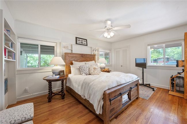 Bedroom with light wood-type flooring, multiple windows, and a closet | Image 17