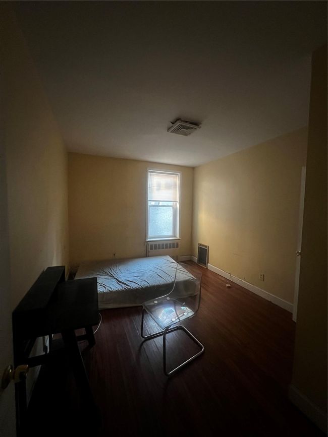 Bedroom featuring wood finished floors and baseboards | Image 6