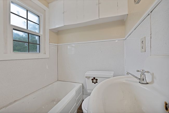 Apartment Full bathroom featuring a sink, a tub, and toilet | Image 34