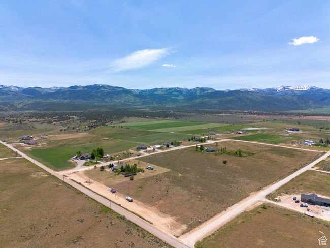 Aerial view of sparsely populated area featuring a mountain backdrop | Image 49