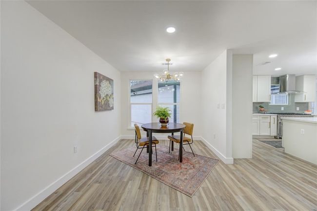 The breakfast room is a charming, sunlit space located just off the kitchen, perfect for casual dining or enjoying a morning cup of coffee. Surrounded by large windows that flood the room with natural light, this area offers a bright, inviting atmosphere to start your day. | Image 8