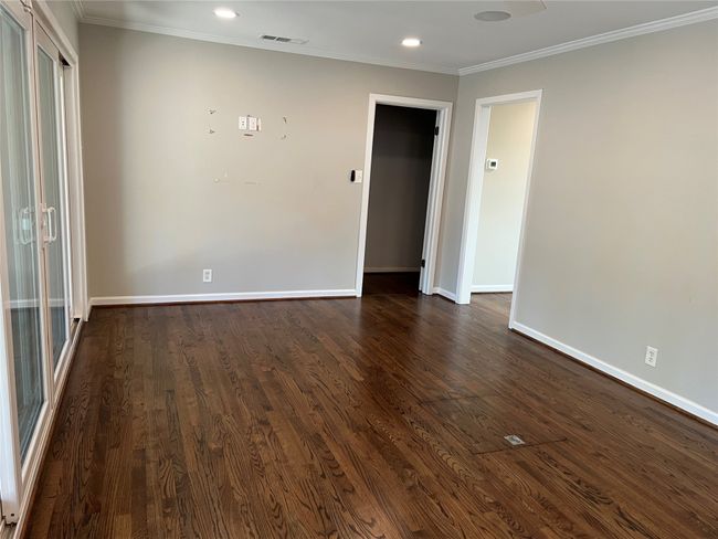 Spare room with ornamental molding, dark wood-style flooring, and recessed lighting | Image 16